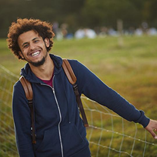 Smiling young man with back pack