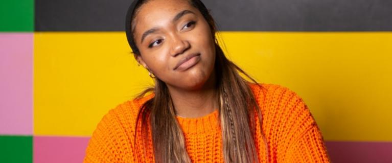 Young woman wearing an orange jumper
